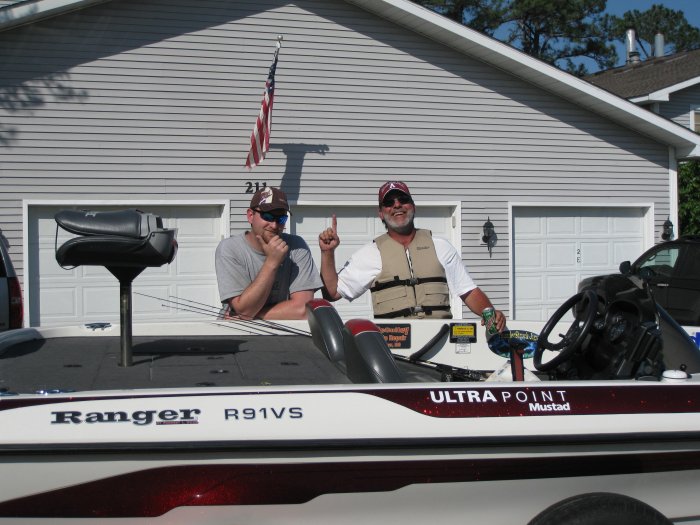 Me with John and his lifejacket, making sure he won't drown in a paved parking lot.